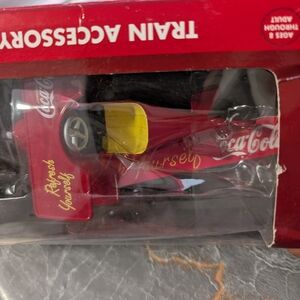 Coca-Cola brand pedal plane train accessory, specifically the K-Line